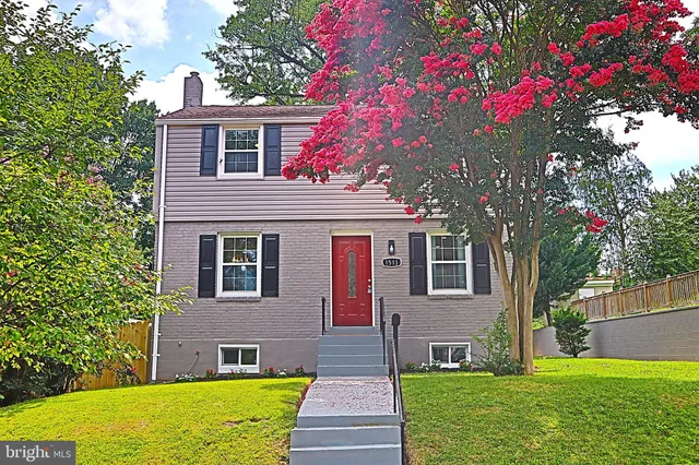 a front view of a house with a yard and fountain