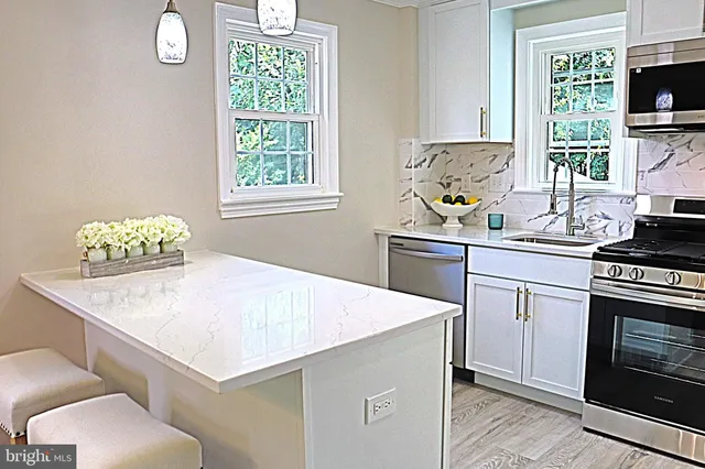 a kitchen with a sink a stove and a window