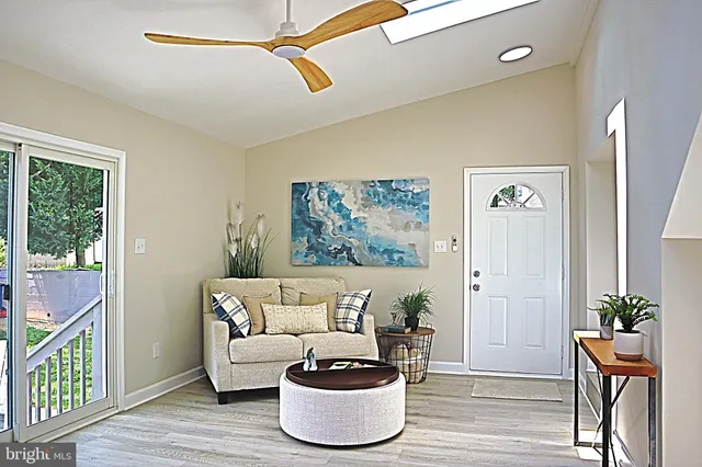 a living room with furniture and a potted plant