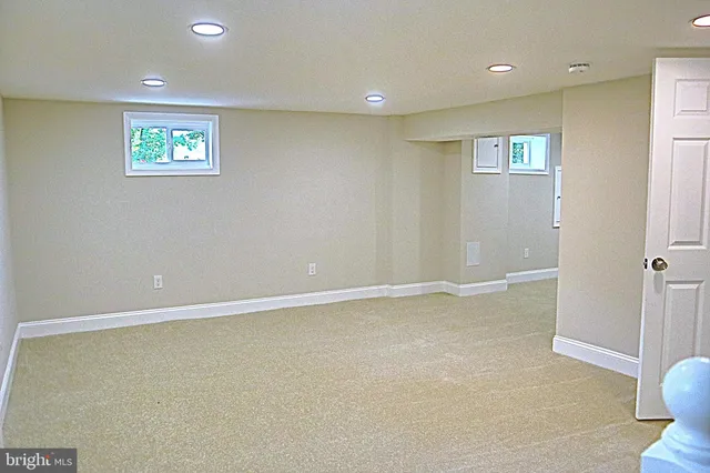 an empty room with windows and closet