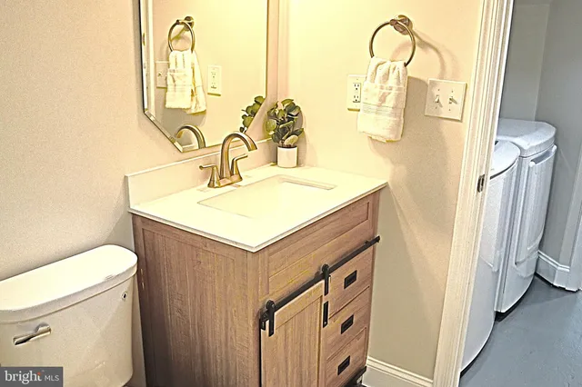 a bathroom with a sink a toilet and a mirror