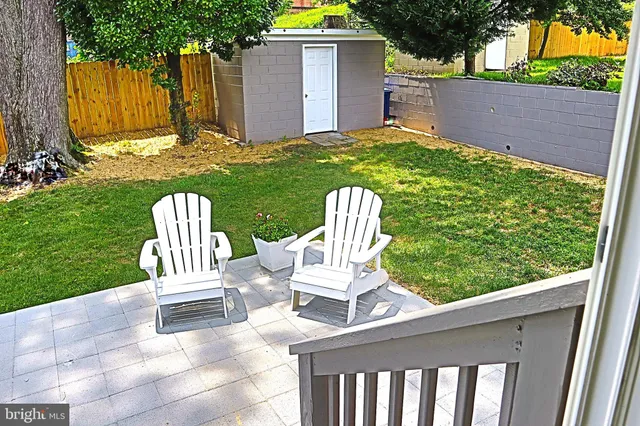 a view of backyard with deck and garden