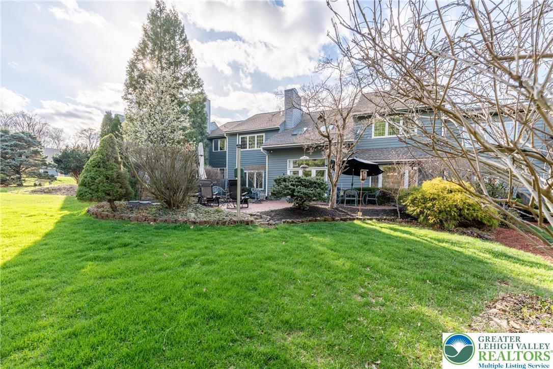 2951 Exeter Drive Emmaus, PA 18049 - Photo 11 of 44 a front view of a house with garden and trees