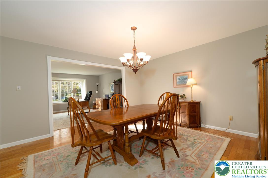 2951 Exeter Drive Emmaus, PA 18049 - Photo 19 of 44 a dining room with furniture a chandelier and wooden floor