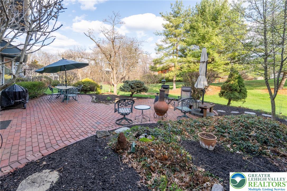 2951 Exeter Drive Emmaus, PA 18049 - Photo 6 of 44 a view of a backyard with table and chairs under an umbrella