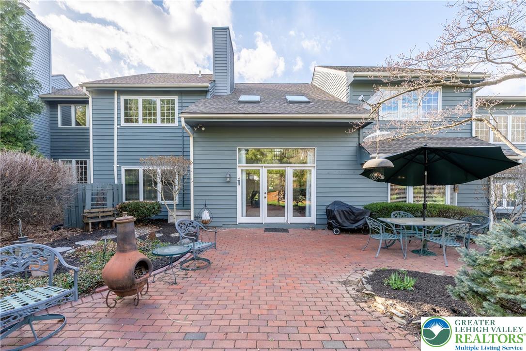 2951 Exeter Drive Emmaus, PA 18049 - Photo 10 of 44 a view of a backyard with table and chairs under an umbrella