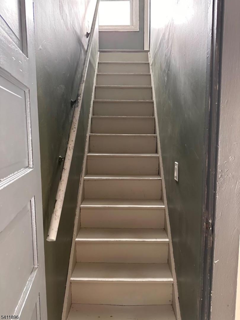 54 Gaston Avenue, Unit 2 Raritan, NJ 08869 - Photo 14 of 16 a view of staircase with white walls and a window