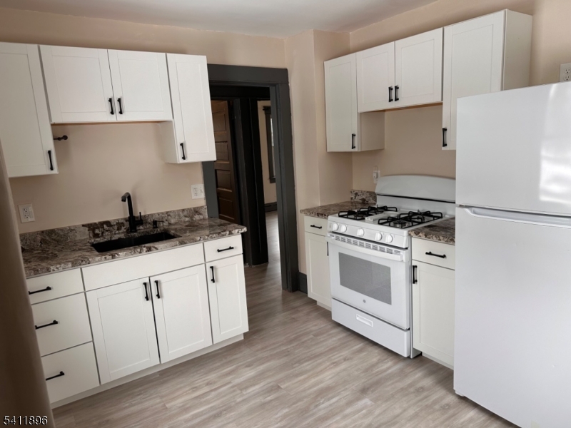 54 Gaston Avenue, Unit 2 Raritan, NJ 08869 - Photo 2 of 16 a kitchen with granite countertop white cabinets and white appliances