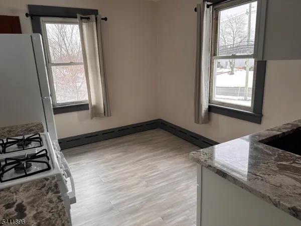 a kitchen with a stove and a window
