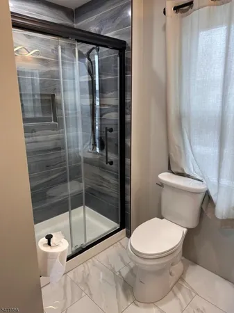 a bathroom with a toilet and a shower
