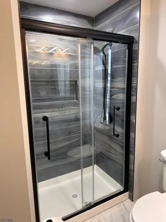 a bathroom with a glass shower door