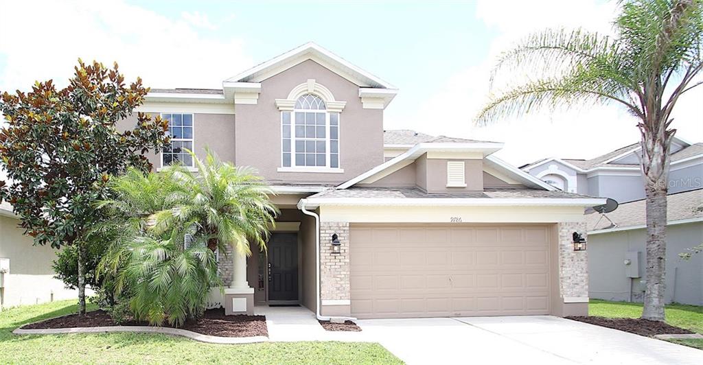 9786 Oak Crest Road Orlando, FL 32829 - Photo 1 of 1 a front view of a house with a garden