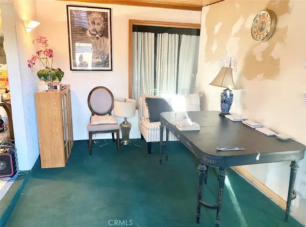 a dining room with furniture and window