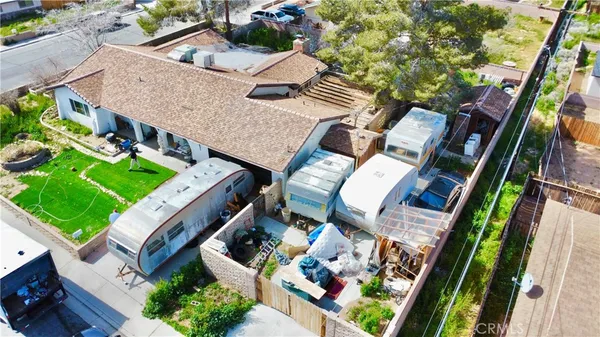 an aerial view of a house with a garden and trees