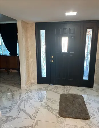 a view of entryway with bedroom and mirror