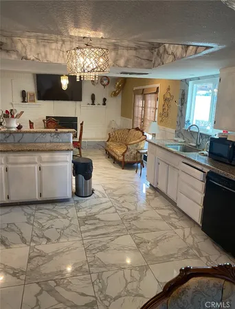 a kitchen with a sink and living room view