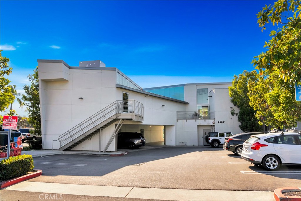 24691 Del Prado Avenue, Unit 100 Dana Point, CA 92629 - Photo 11 of 31 a car parked in front of a building