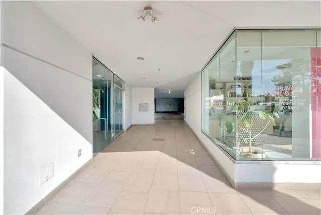 a hallway with a glass door and shower