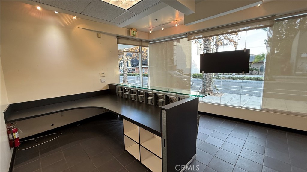 24691 Del Prado Avenue, Unit 100 Dana Point, CA 92629 - Photo 19 of 31 a room with furniture and flat screen tv