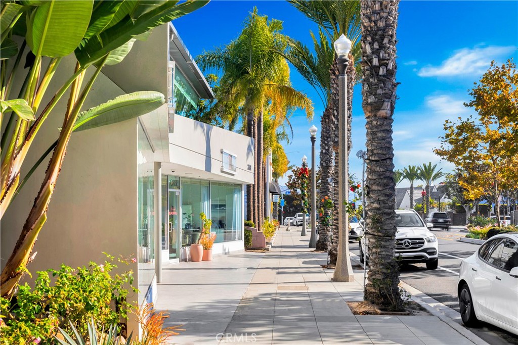 24691 Del Prado Avenue, Unit 100 Dana Point, CA 92629 - Photo 2 of 31 a view of a street with cars parked