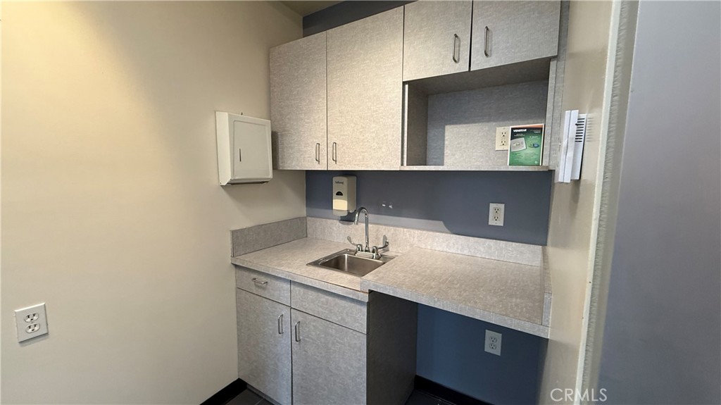 24691 Del Prado Avenue, Unit 100 Dana Point, CA 92629 - Photo 27 of 31 a bathroom with a sink and a mirror