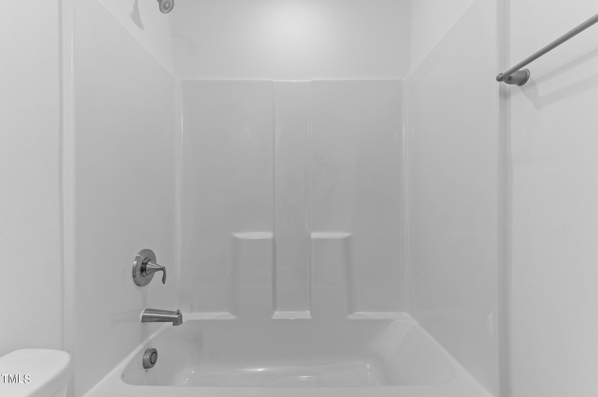 207 South Nash Street, Unit AB Bunn, NC 27508 - Photo 13 of 25 a bathroom with a white bath tub and a sink