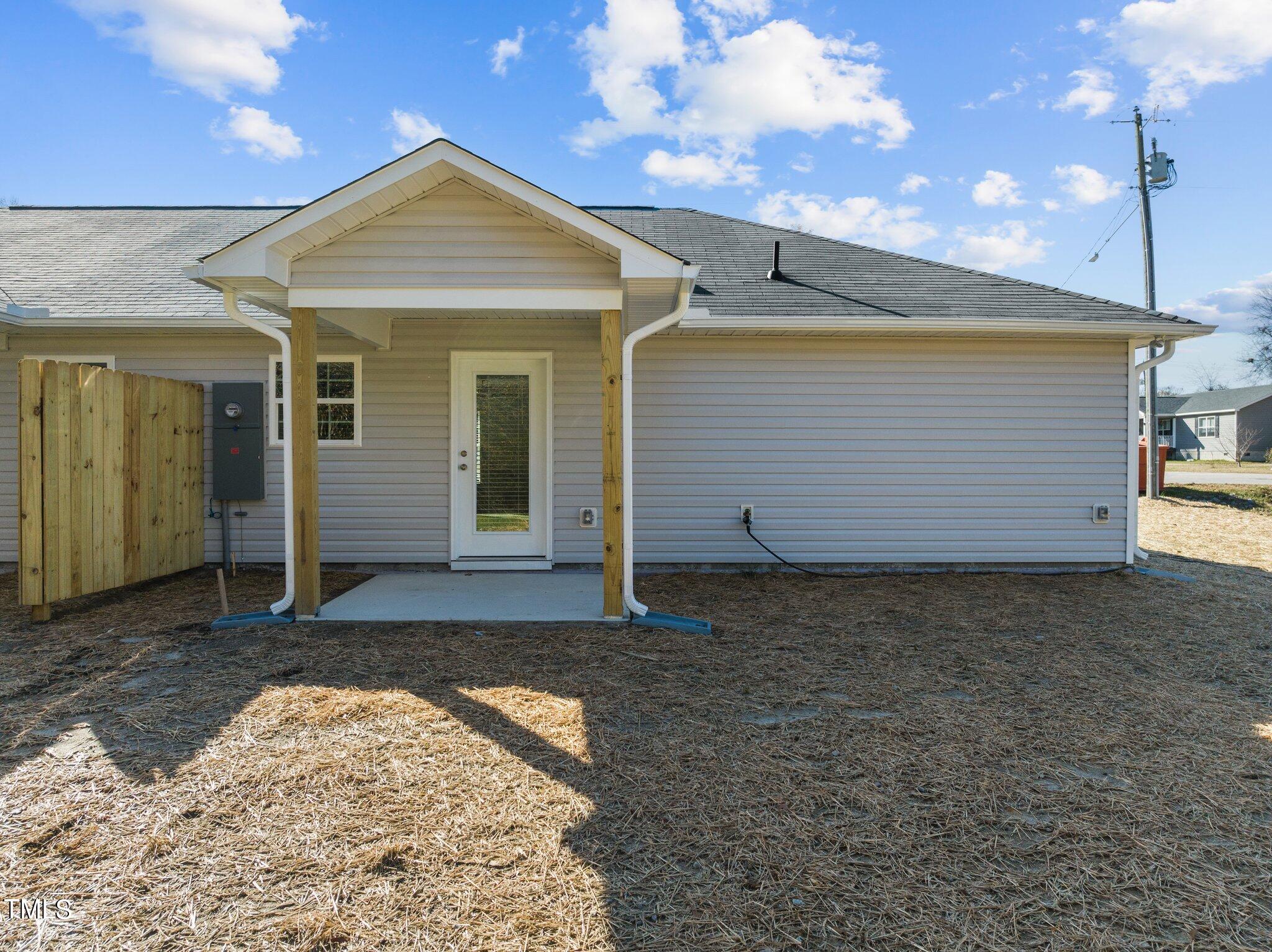 207 South Nash Street, Unit AB Bunn, NC 27508 - Photo 19 of 25 a view of a house with a yard