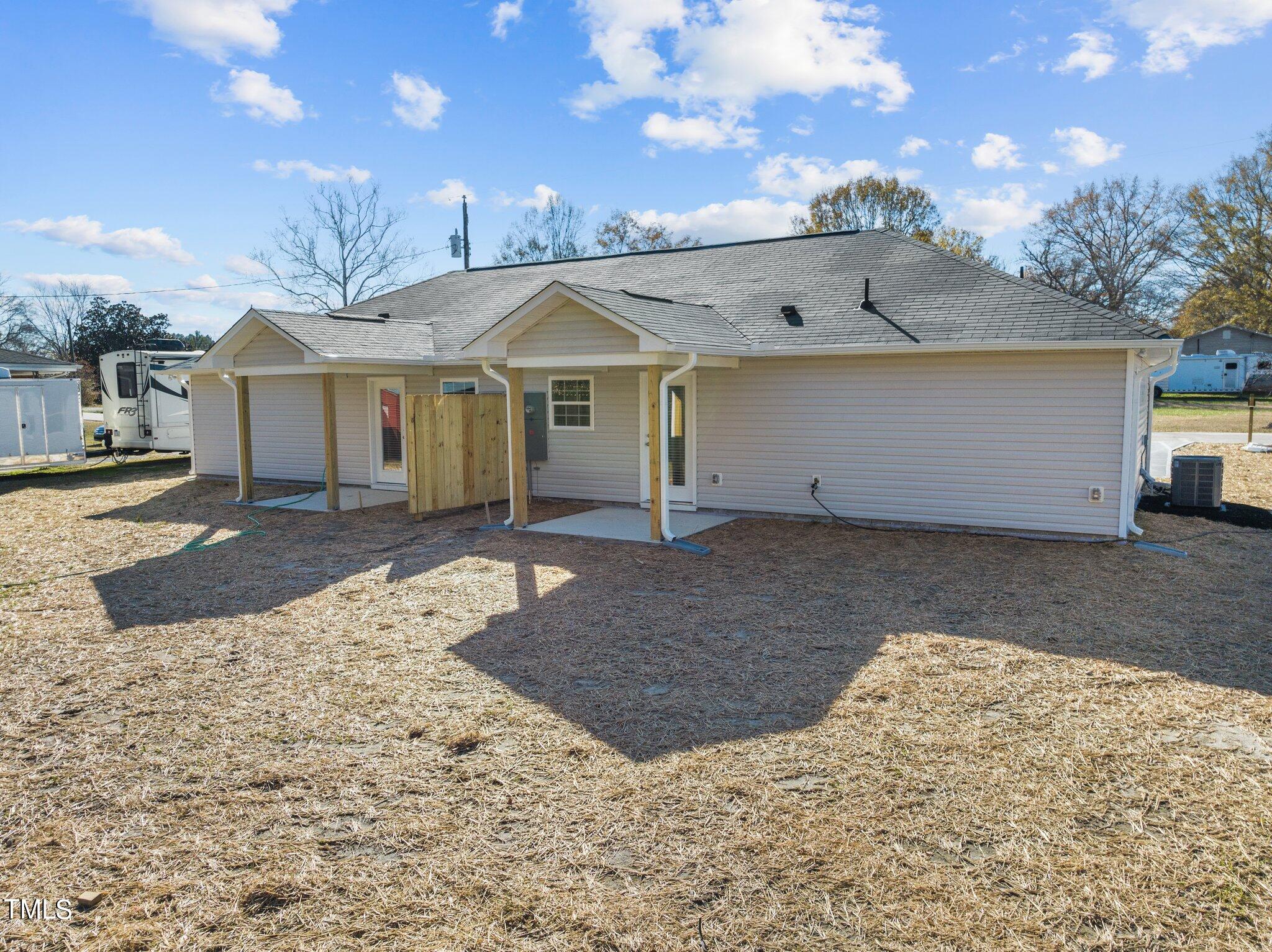 207 South Nash Street, Unit AB Bunn, NC 27508 - Photo 20 of 25 a view of a white house with a yard