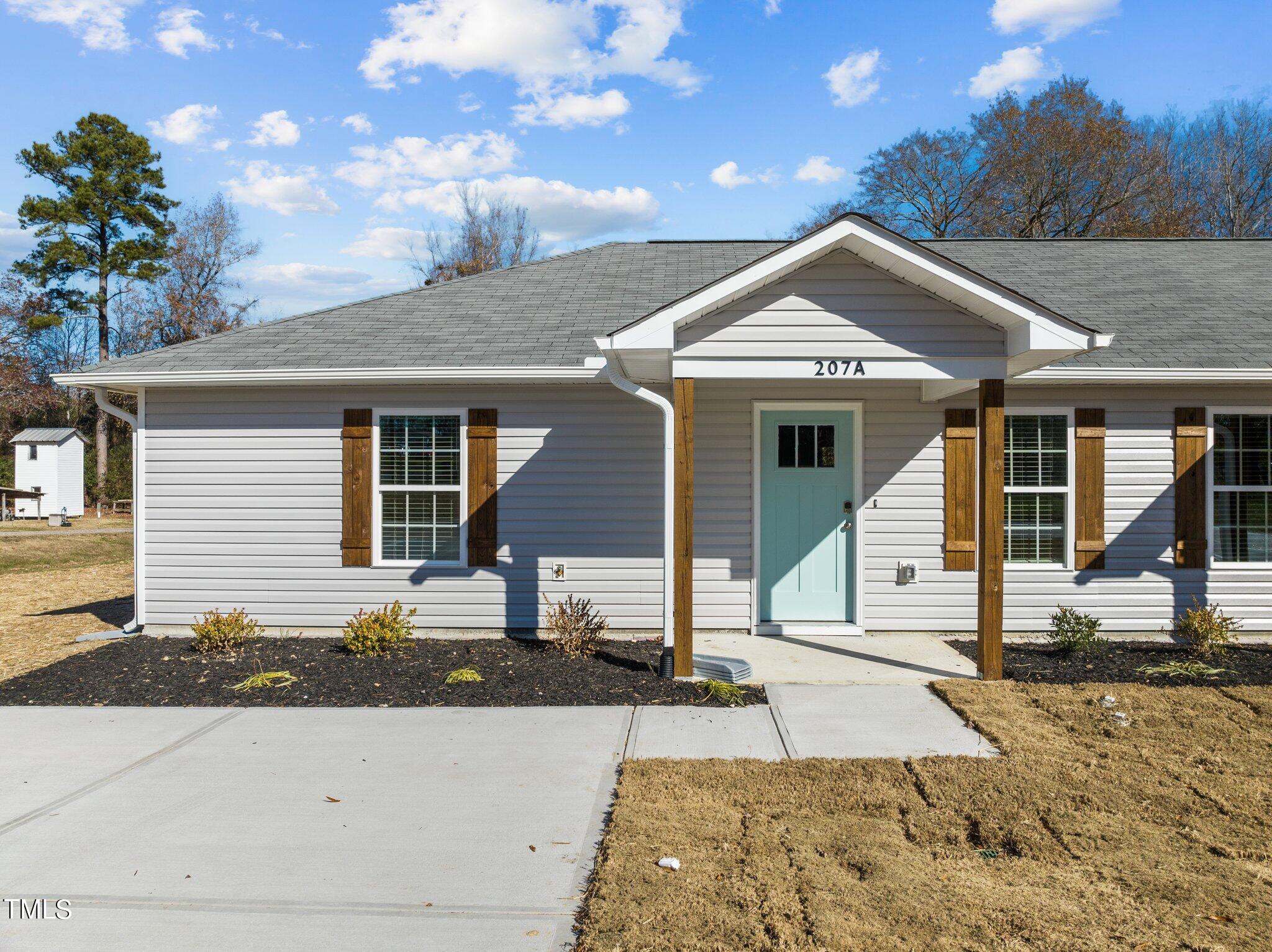 207 South Nash Street, Unit AB Bunn, NC 27508 - Photo 25 of 25 a front view of a house with a yard