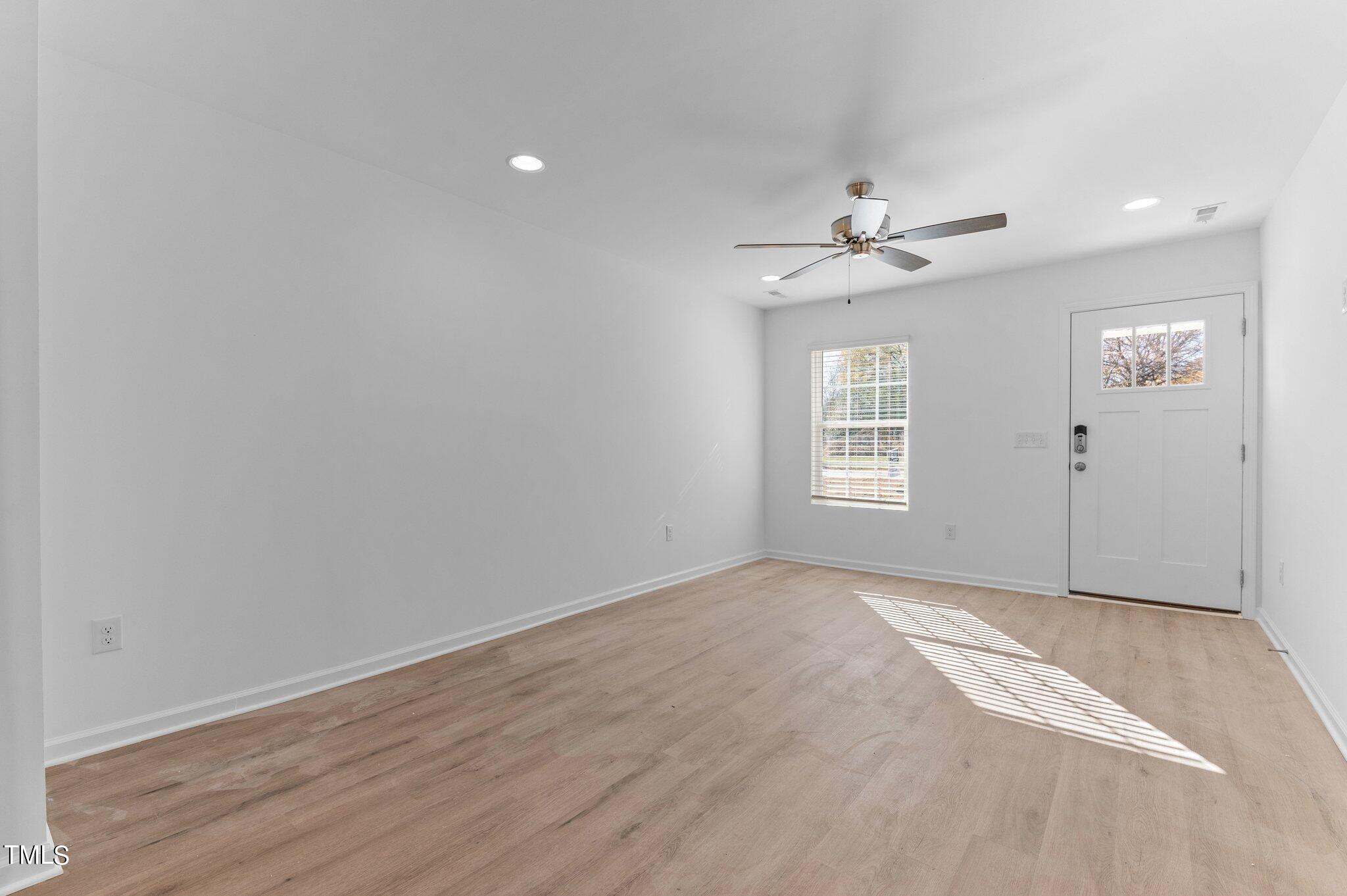 207 South Nash Street, Unit AB Bunn, NC 27508 - Photo 7 of 25 a view of an empty room with a window
