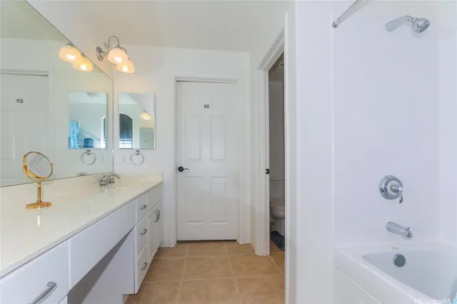 a bathroom with a tub sink and mirror