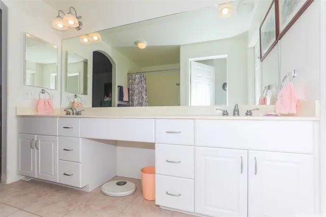 a bathroom with a sink vanity and mirror