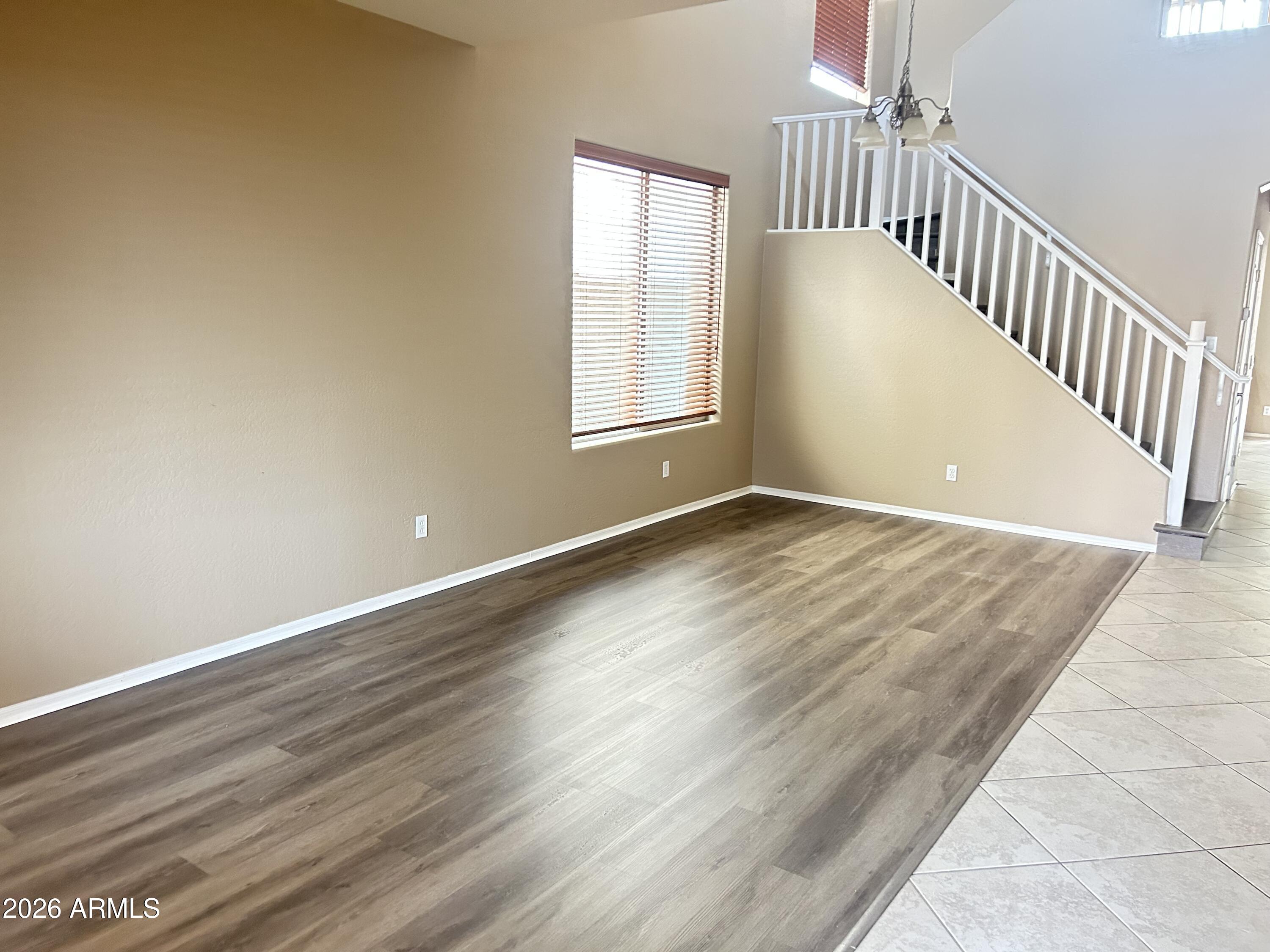 7089 West Eagle Ridge Lane Peoria, AZ 85383 - Photo 13 of 27 a view of an empty room with wooden floor and a window