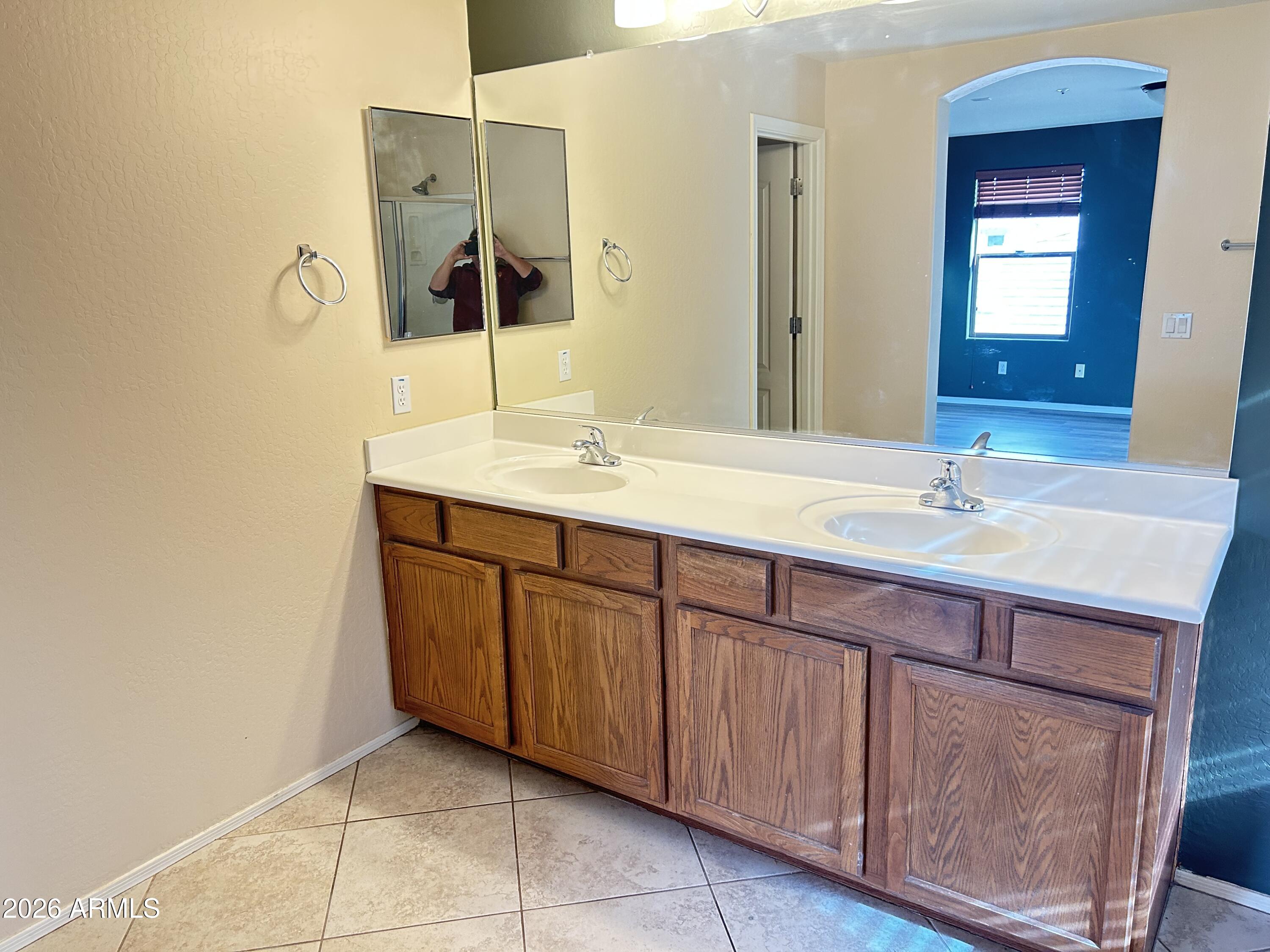 7089 West Eagle Ridge Lane Peoria, AZ 85383 - Photo 19 of 27 a bathroom with a sink and a mirror