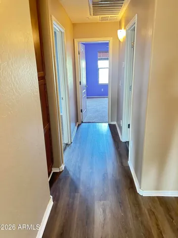 a view of a hallway with wooden floor