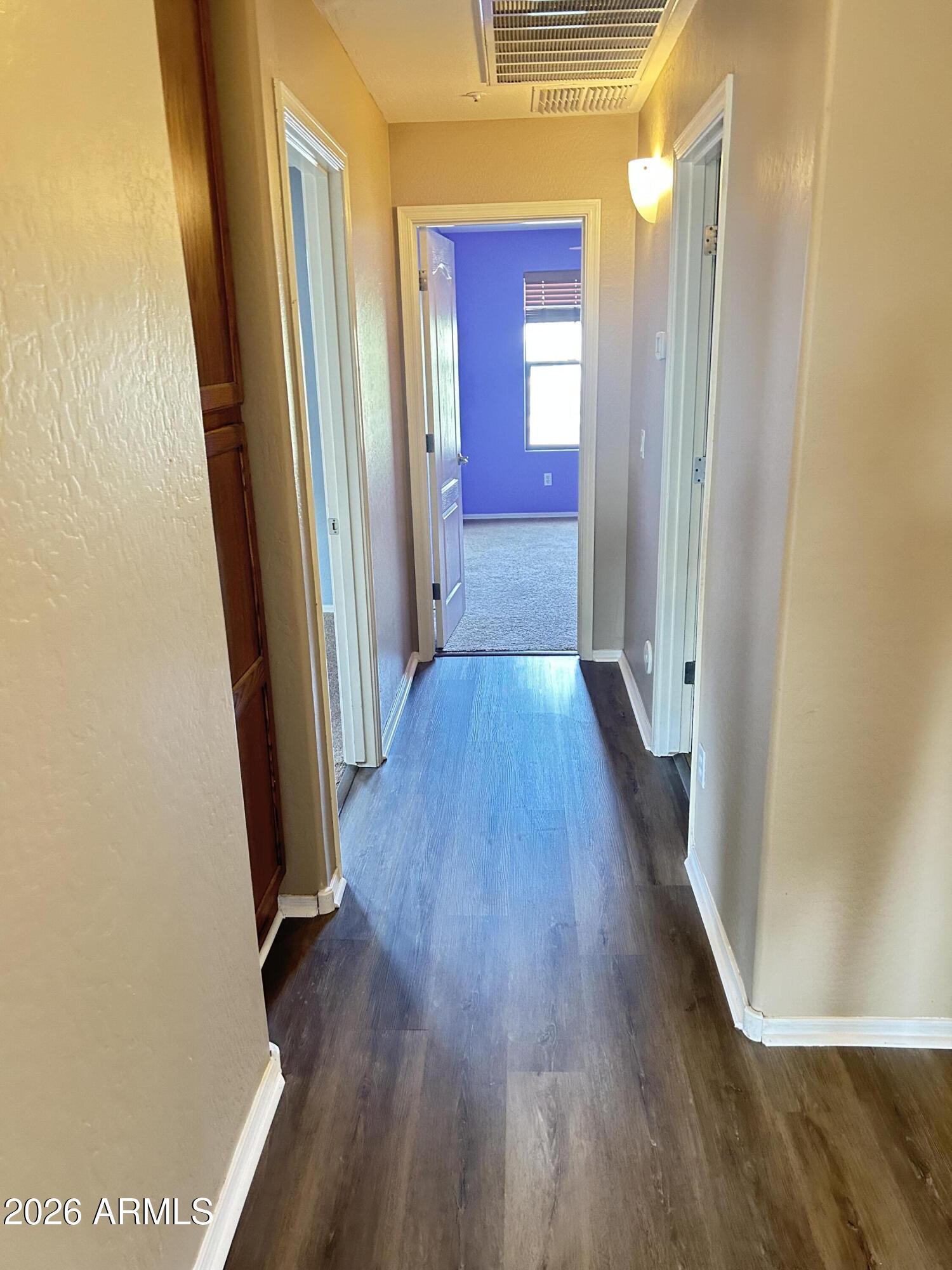 7089 West Eagle Ridge Lane Peoria, AZ 85383 - Photo 20 of 27 a view of a hallway with wooden floor