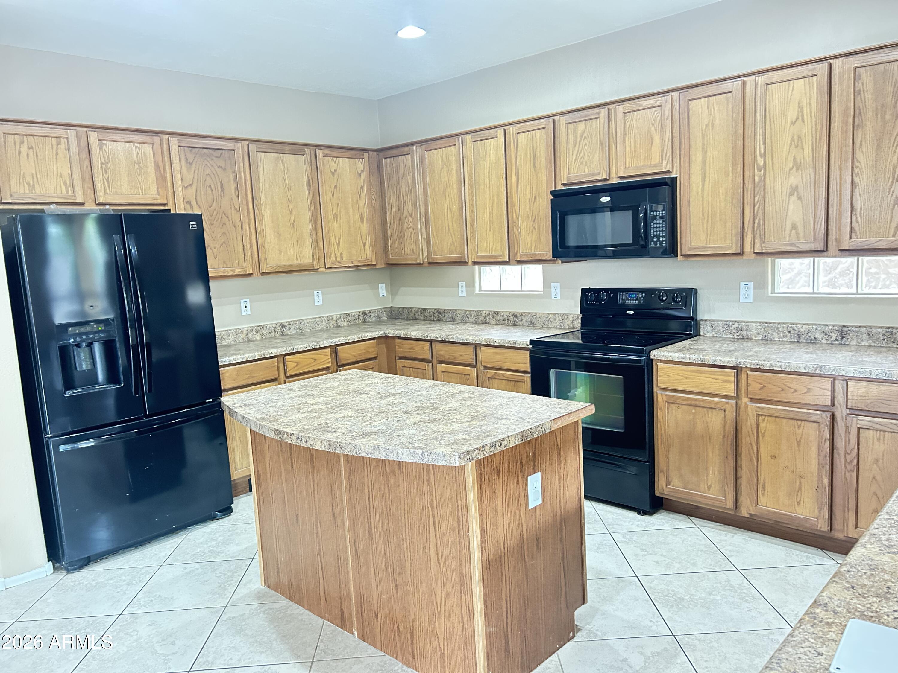 7089 West Eagle Ridge Lane Peoria, AZ 85383 - Photo 2 of 27 a kitchen with stainless steel appliances granite countertop a stove a sink dishwasher a refrigerator and cabinets with wooden floor