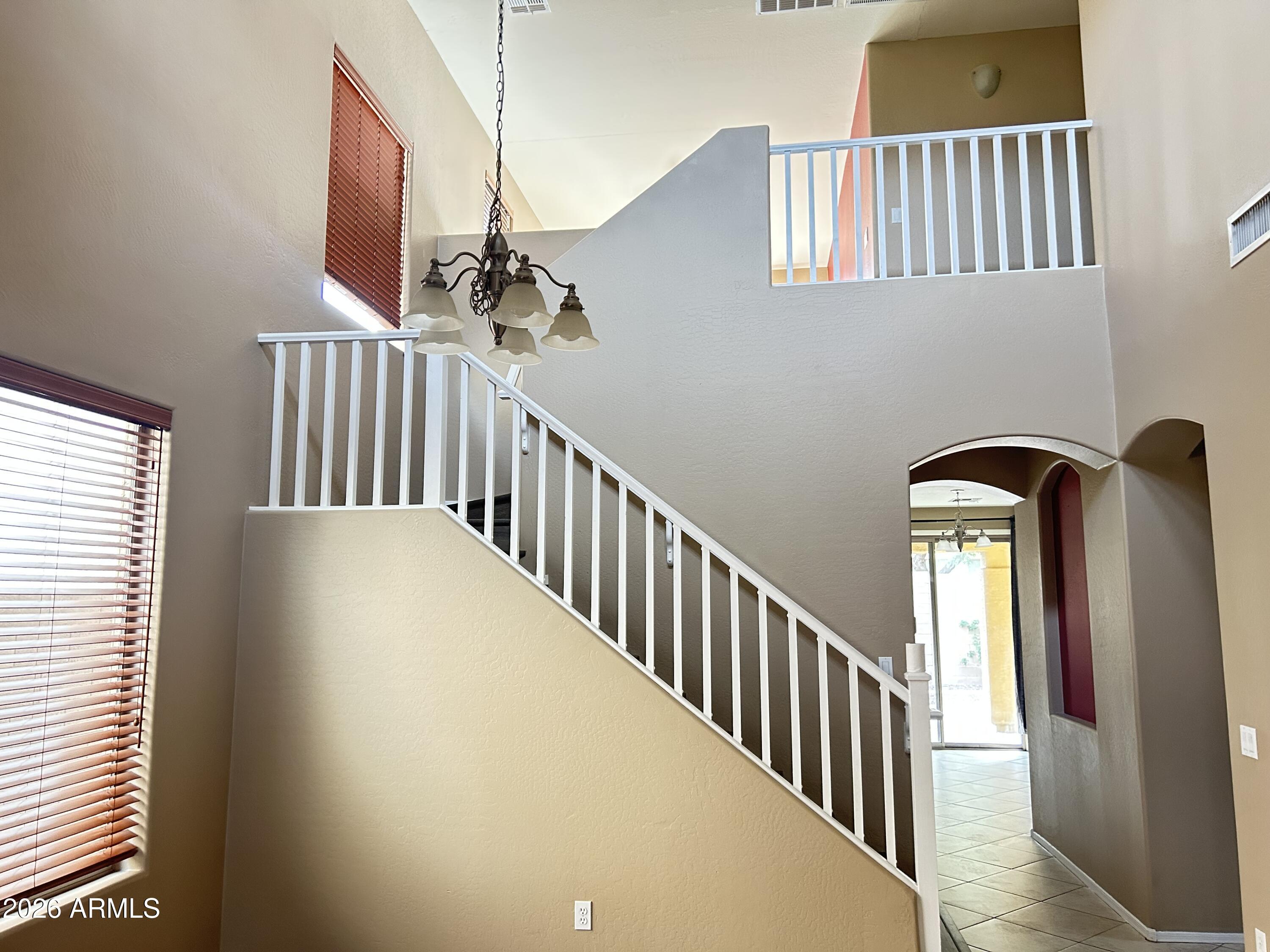 7089 West Eagle Ridge Lane Peoria, AZ 85383 - Photo 22 of 27 a view of staircase with railing and a window