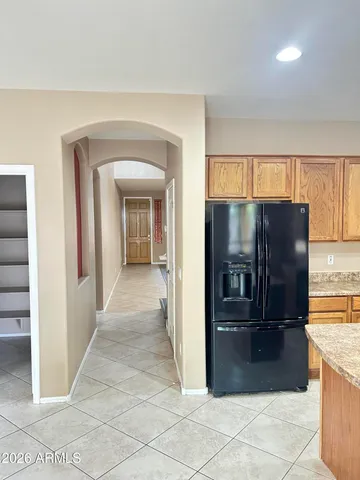a view of a refrigerator in kitchen and a windows