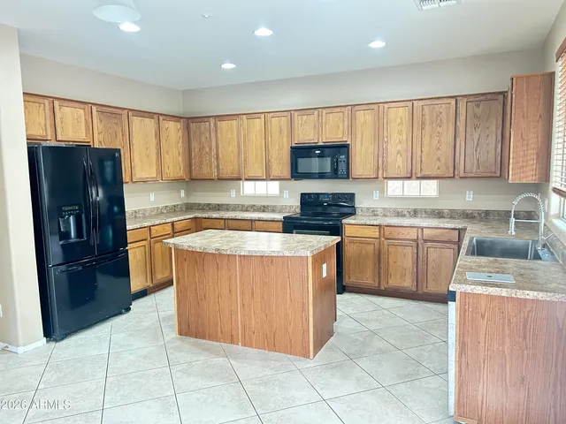 a kitchen with stainless steel appliances granite countertop a stove a sink dishwasher a refrigerator and a oven