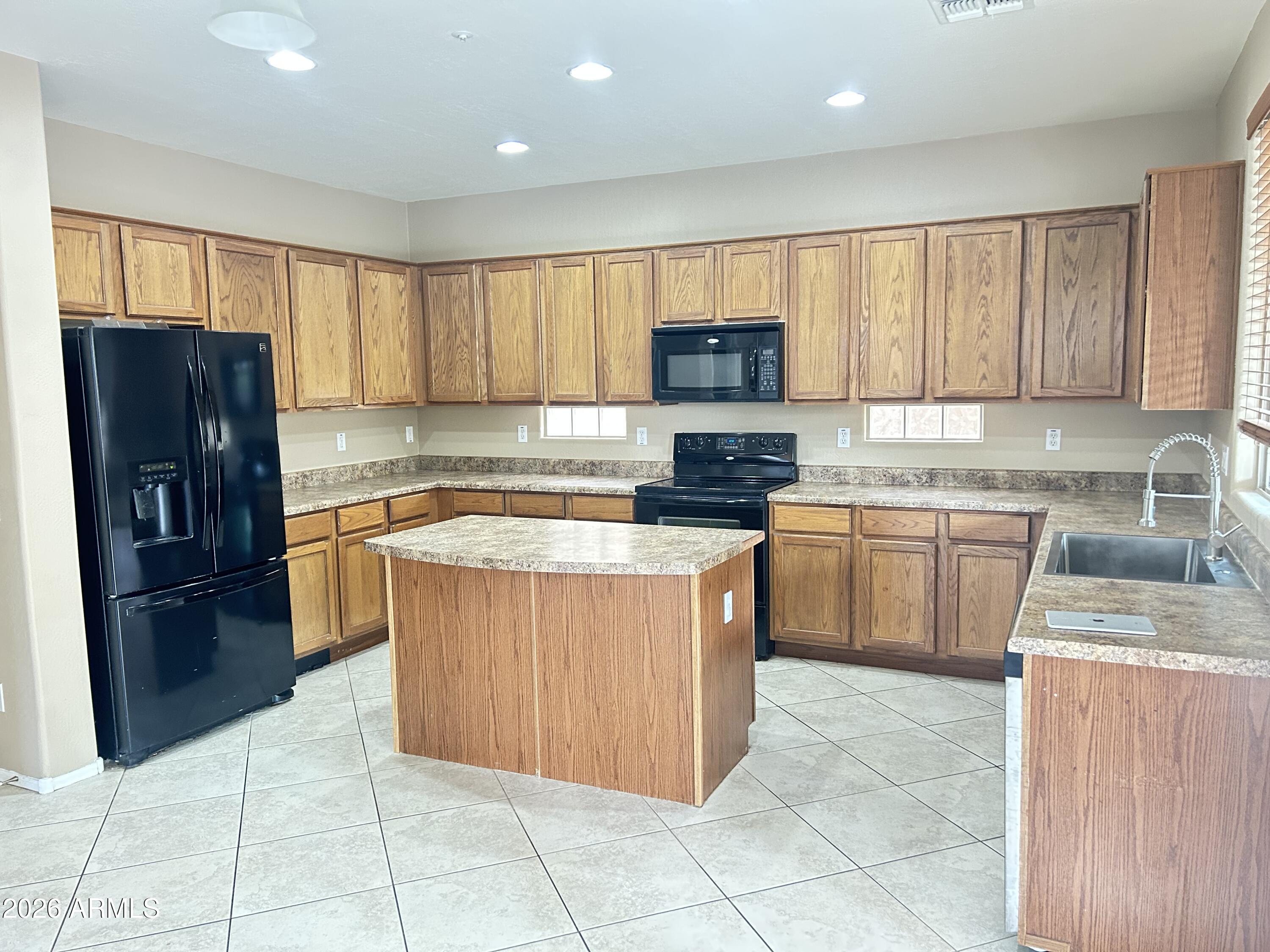 7089 West Eagle Ridge Lane Peoria, AZ 85383 - Photo 4 of 27 a kitchen with stainless steel appliances granite countertop a stove a sink dishwasher a refrigerator and a oven