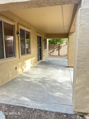 a view of a house with a backyard and floor to ceiling window