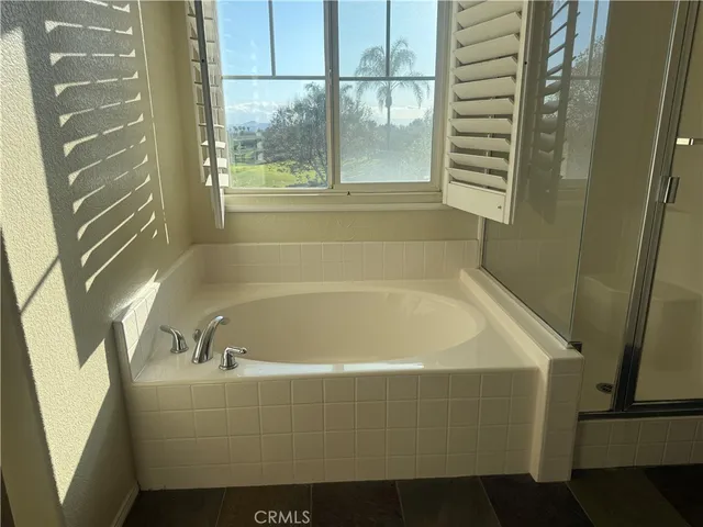 a white bath tub sitting next to a window