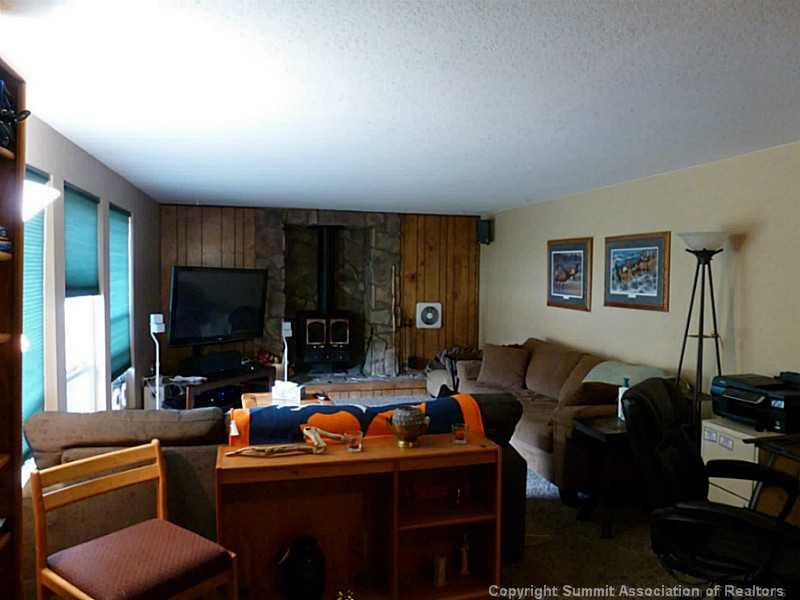 461 Alpine Road Dillon, CO 80435 - Photo 5 of 13 a living room with furniture a flat screen tv and kitchen view