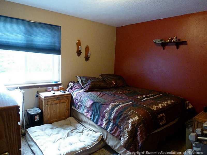461 Alpine Road Dillon, CO 80435 - Photo 7 of 13 a bed sitting in a bedroom next to a window