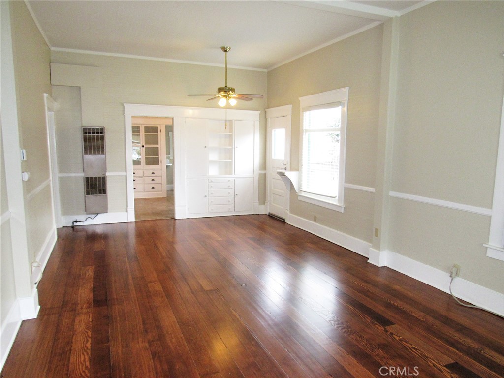 478 South Grand Street Orange, CA 92866 - Photo 2 of 10 an empty room with wooden floor and windows