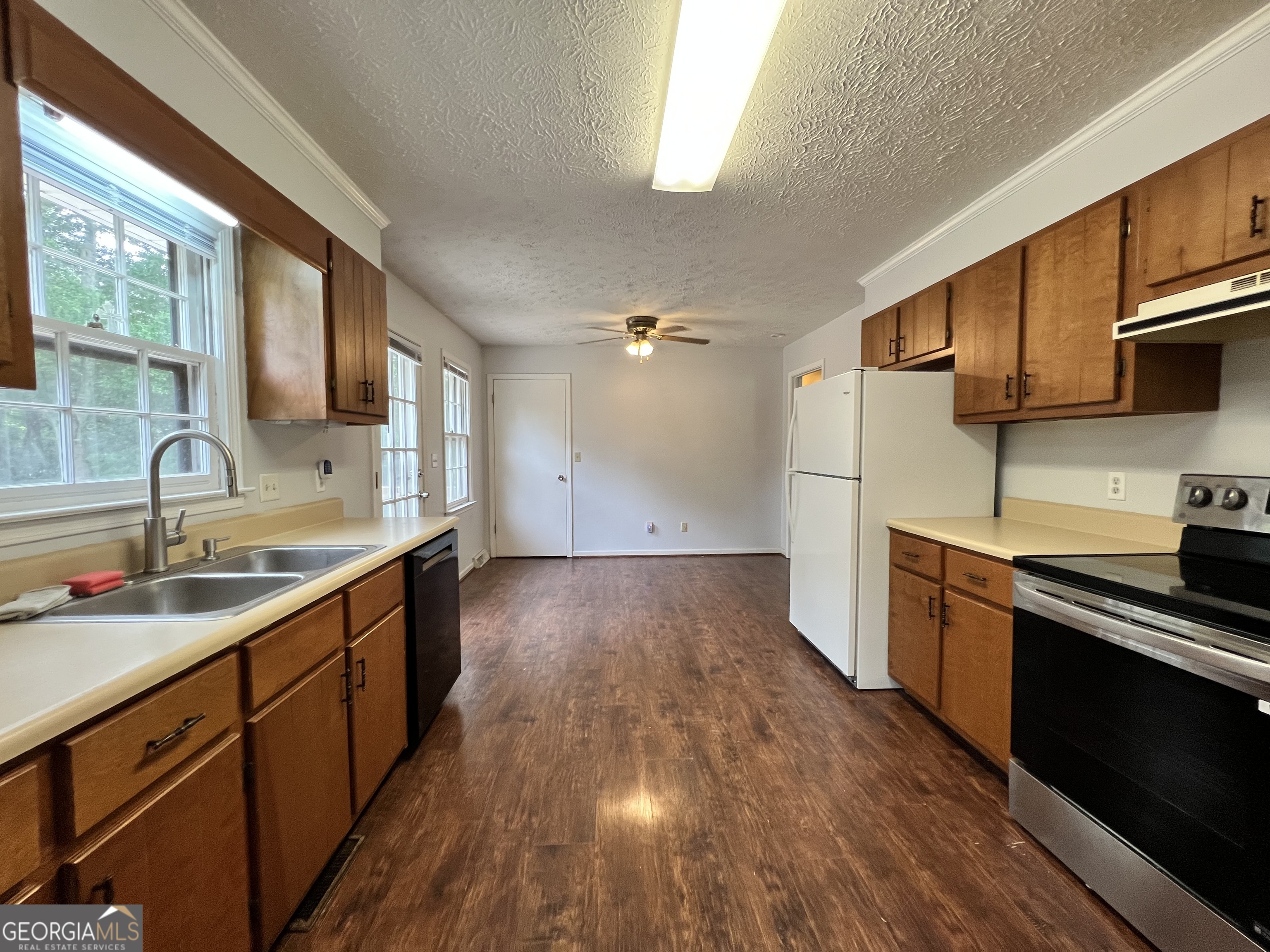 32 Ford Drive Southeast Rome, GA 30161 - Photo 9 of 49 a kitchen with wooden floors and stainless steel appliances