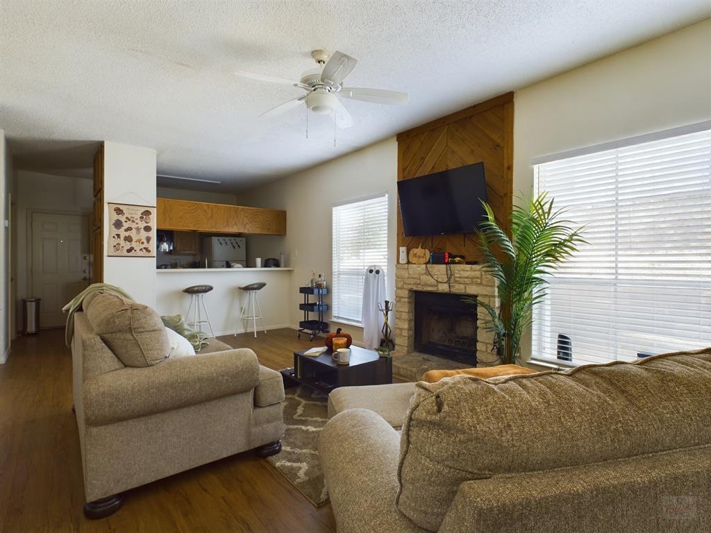 2313 Longview Street, Unit 102 Austin, TX 78705 - Photo 3 of 14 a living room with fireplace furniture and a flat screen tv