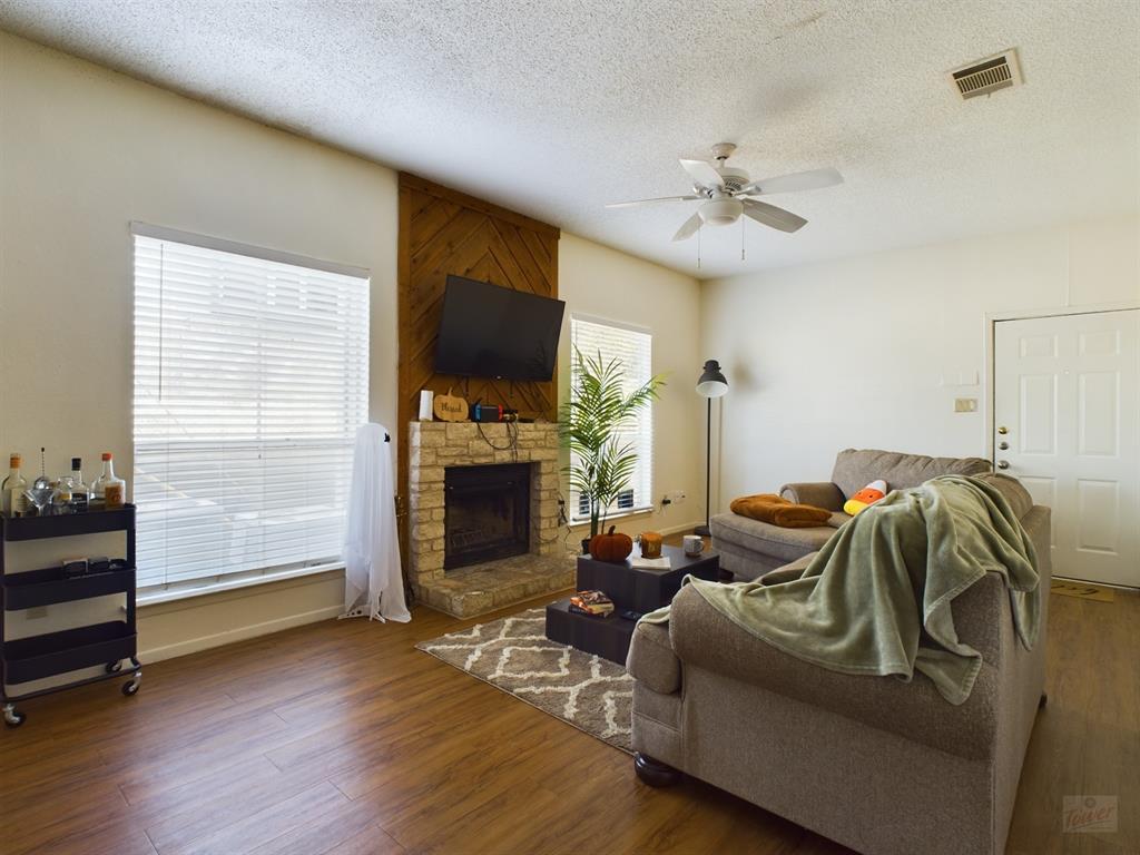 2313 Longview Street, Unit 102 Austin, TX 78705 - Photo 4 of 14 a living room with furniture and a fireplace