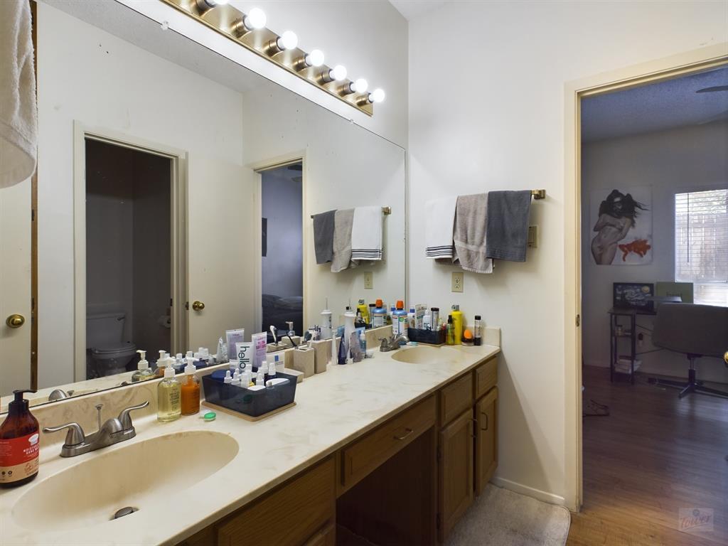 2313 Longview Street, Unit 102 Austin, TX 78705 - Photo 8 of 14 a bathroom with a sink double vanity and a mirror